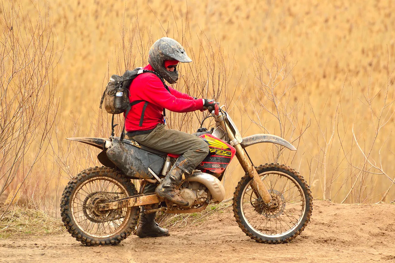 Off-road vehicle kicking up dust on rural track